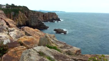 Sandanbeki Cliffs, Shirahama, Wakayama Prefecture, Japan. Sandanbeki consists of three steep cliffs with a large network of caves at water level.