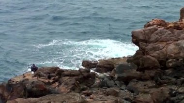 Sandanbeki Cliffs, Shirahama, Wakayama Prefecture, Japan. Sandanbeki consists of three steep cliffs with a large network of caves at water level.