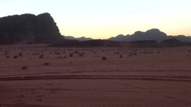 tourist cars driving in of Wadi Rum desert in the Hashemite Kingdom of Jordan, also known as The Valley of Moon
