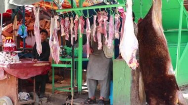 Unidentified people at  meat market in Kabul, the capital of Afghanistan, circa May 2019