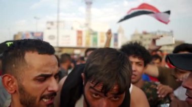 2019 'daki Irak protestolarında Irak hükümetine karşı gösteri yapan kimliği belirsiz kişiler, ayrıca 2019' da Bağdat 'ta Tishreen Devrimi veya Irak İntifadası olarak adlandırıldı.