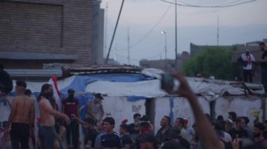 Unidentified people demonstrating against the Iraqi government at the 2019 Iraqi protests, also named Tishreen Revolution or Iraqi Intifada in Baghdad, 2019