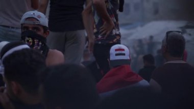 2019 'daki Irak protestolarında Irak hükümetine karşı gösteri yapan kimliği belirsiz kişiler, ayrıca 2019' da Bağdat 'ta Tishreen Devrimi veya Irak İntifadası olarak adlandırıldı.
