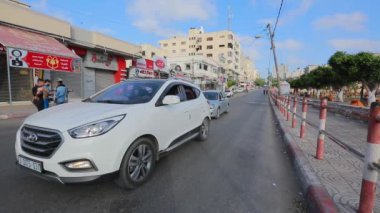 Unidentified people and street traffic in Gaza City, West Bank, the largest city of the State of Palestine, circa August 2021