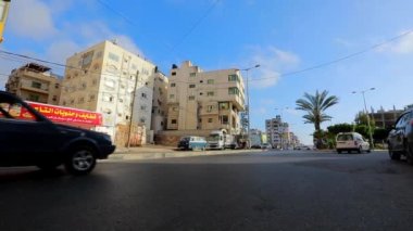 Unidentified people and street traffic in Gaza City, West Bank, the largest city of the State of Palestine, circa August 2021