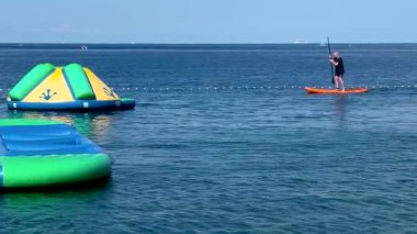 Güneşli bir günde, Adriyatik kıyılarının yakınında kürek çeken bir adamın görüntüsü.