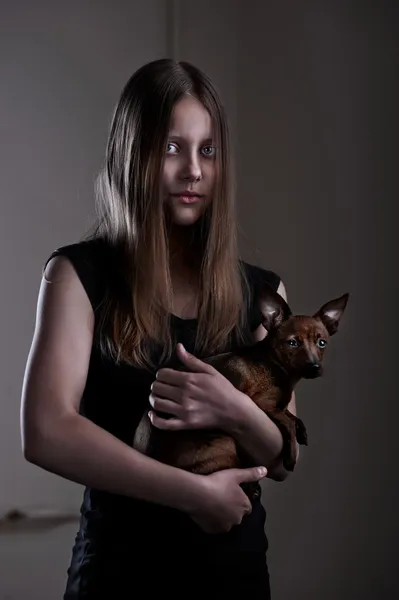 Beautiful evil teen girl with little doggy — Stock Photo, Image