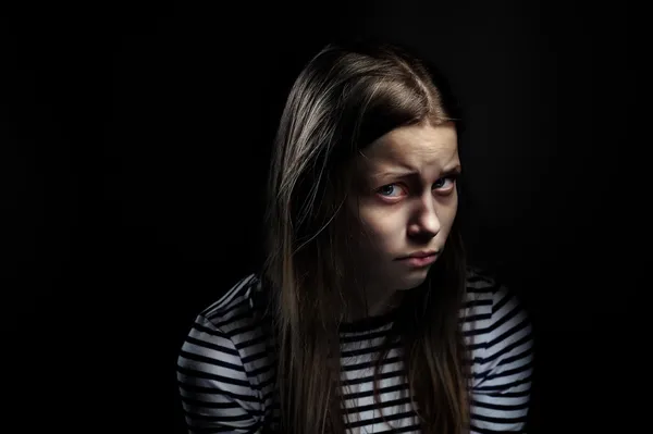 Dark portrait of a depressed teen girl, studio shot — Stock Photo, Image