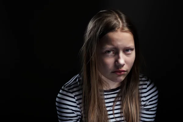 Dark portrait of a crying teen girl, studio shot — Stock Photo, Image