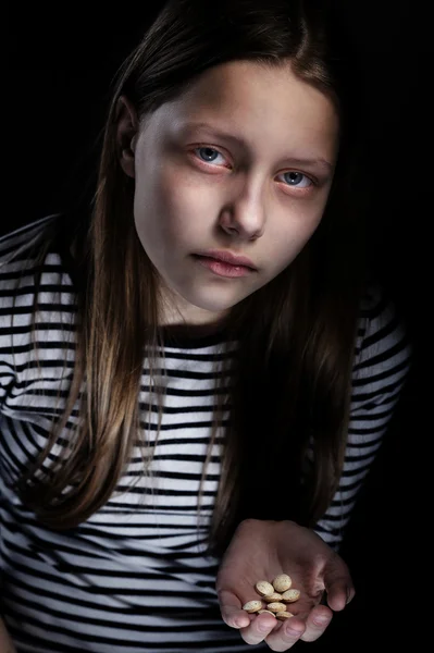 Dark portrait of a drug addicted teenager girl with pills — Stock Photo, Image
