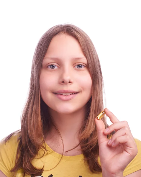 Adolescente chica con una píldora aislada en blanco —  Fotos de Stock