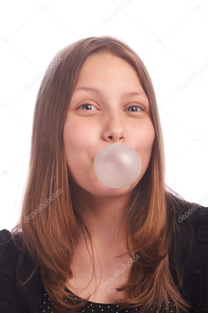 teen girl blowing bubbles on white background