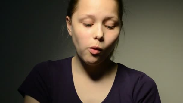 Девочка-подросток жует жвачку и пускает пузырь — стоковое видео