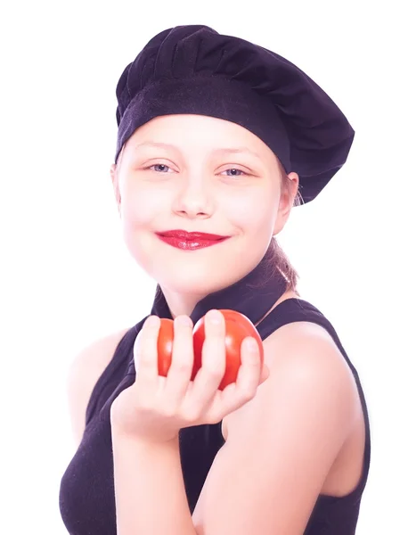 Teen girl in chef hat with tomatoes — Stock Photo, Image