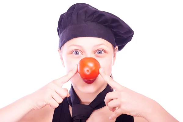 Dziewczyna w kuchni kapelusz z pomidorami — Zdjęcie stockowe
