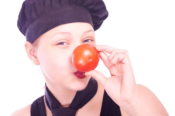 Menina adolescente em chapéu de chef com tomates — Fotografia de Stock