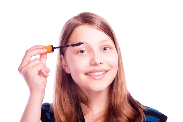 Teen girl paints eyelashes — Stock Photo, Image