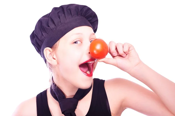 Teen girl in chef hat with tomatoes — Stock Photo, Image