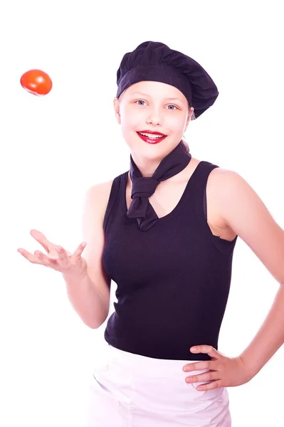 Jeune fille dans chapeau de chef avec des tomates — Photo