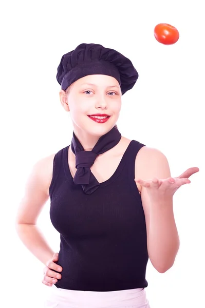 Ragazza adolescente in cappello da chef con pomodori — Foto Stock