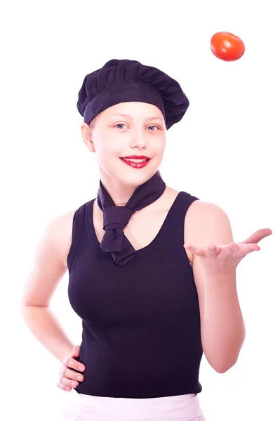 Teen girl in chef hat with tomatoes — Stock Photo, Image