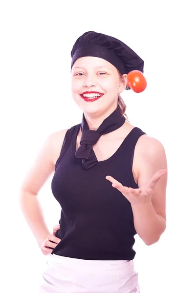 Teen girl in chef hat with tomatoes — Stock Photo, Image