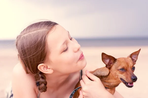 Teen girl playing with her dog — Stock Photo, Image