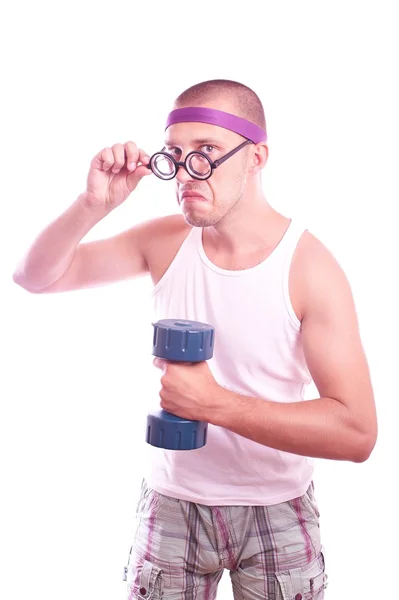 Nerd in glasses with dumbbell trains — Stock Photo, Image