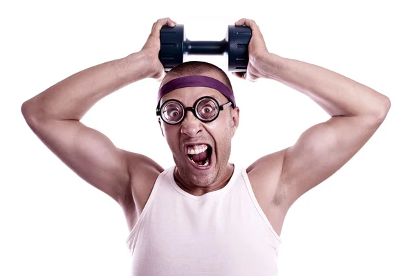 Nerd in glasses with dumbbell trains — Stock Photo, Image