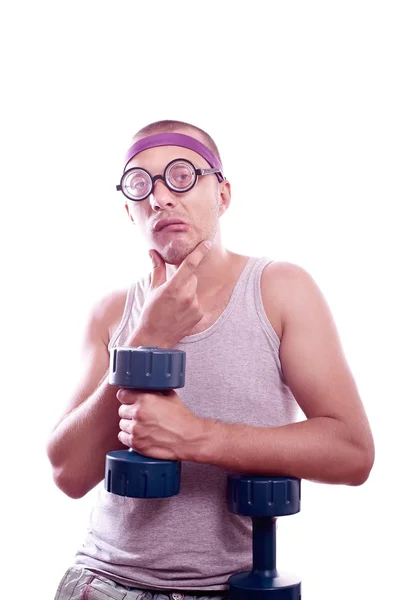 Nerd in glasses with dumbbell trains — Stock Photo, Image