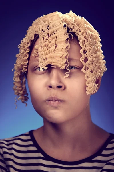 Angry teen girl with macaroni instead hair — Stock Photo, Image