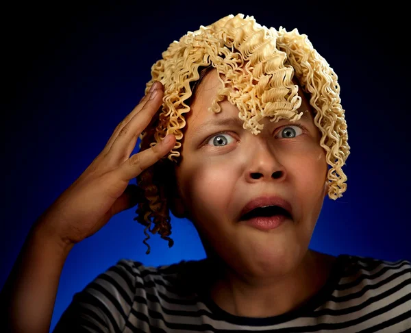 Shocked teen girl with macaroni instead hair — Stock Photo, Image