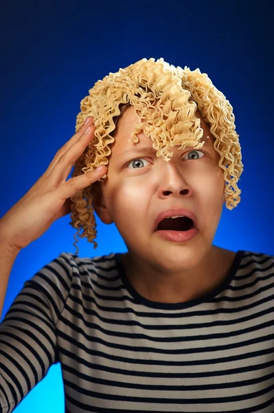 Shocked teen girl with macaroni instead hair — Stock Photo, Image