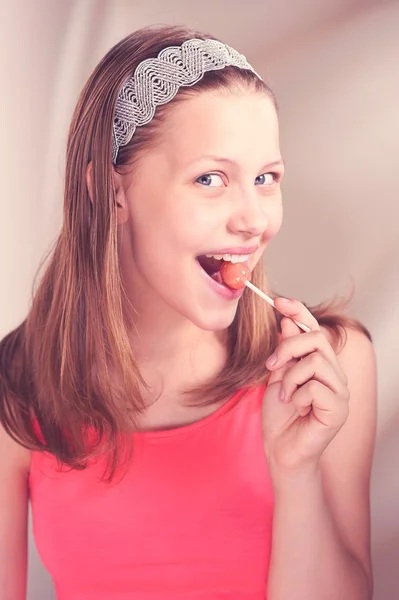 Funny teen girl eating lollypop — Stock Photo, Image