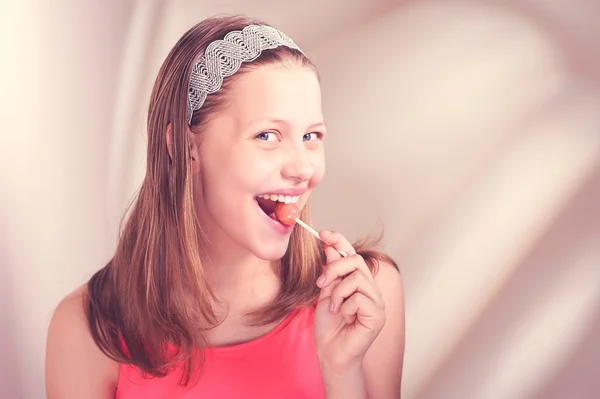 Funny teen girl eating lollypop Stock Picture