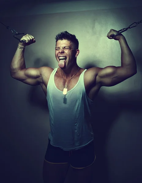 Guy trains his pecs using crossover — Stock Photo, Image