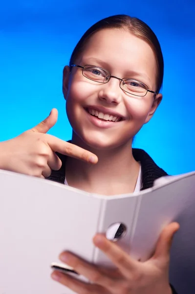 Young businesswoman in eyeglasses shows on folder with finger — Stock Photo, Image