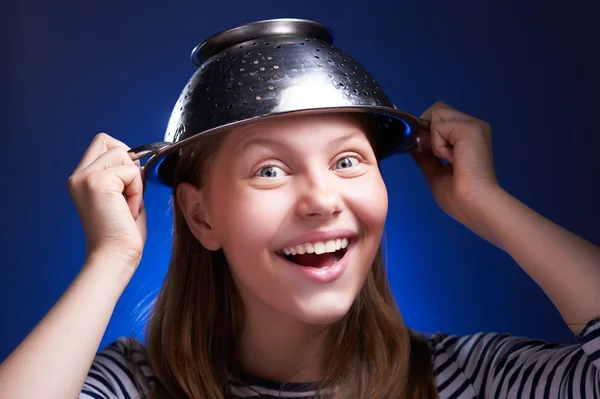 Girl with a colander on her head — Stock Photo, Image