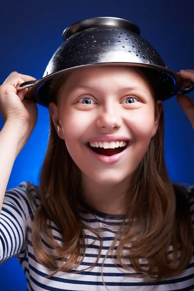 Girl with a colander on her head — Stock Photo, Image