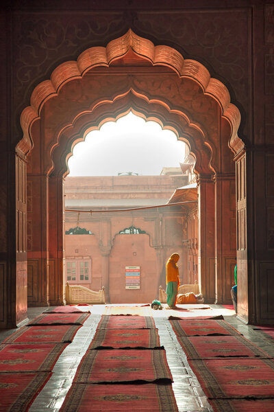 praying at the Jama Masjid Mosque, old Delhi, India.