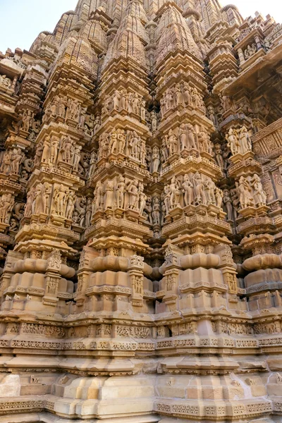 Kamasutra scene on the wall of a Temple in Khajuraho. Stock Photo