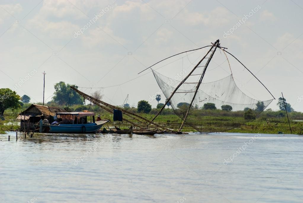 Fishing net and houseboat. Tonle Sap Lake, Cambodia. — Stock Photo ©  masterlu #13825980