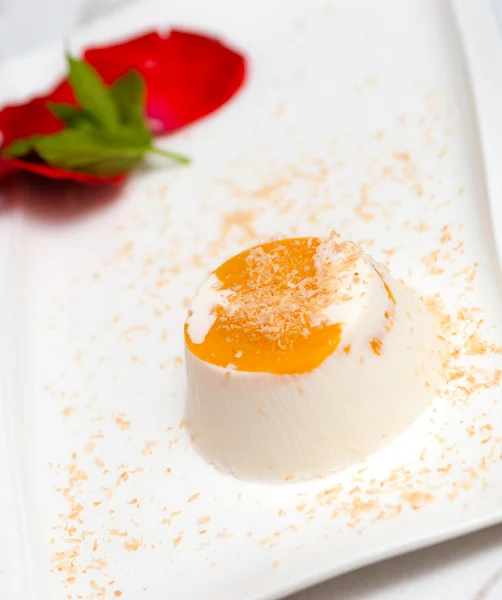 Italian dessert panna cotta on white plate decorated with coconut milk — Stock Photo, Image