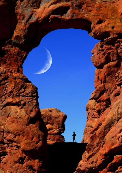 Man Hiking Under Arch with Moon — Stock Photo, Image