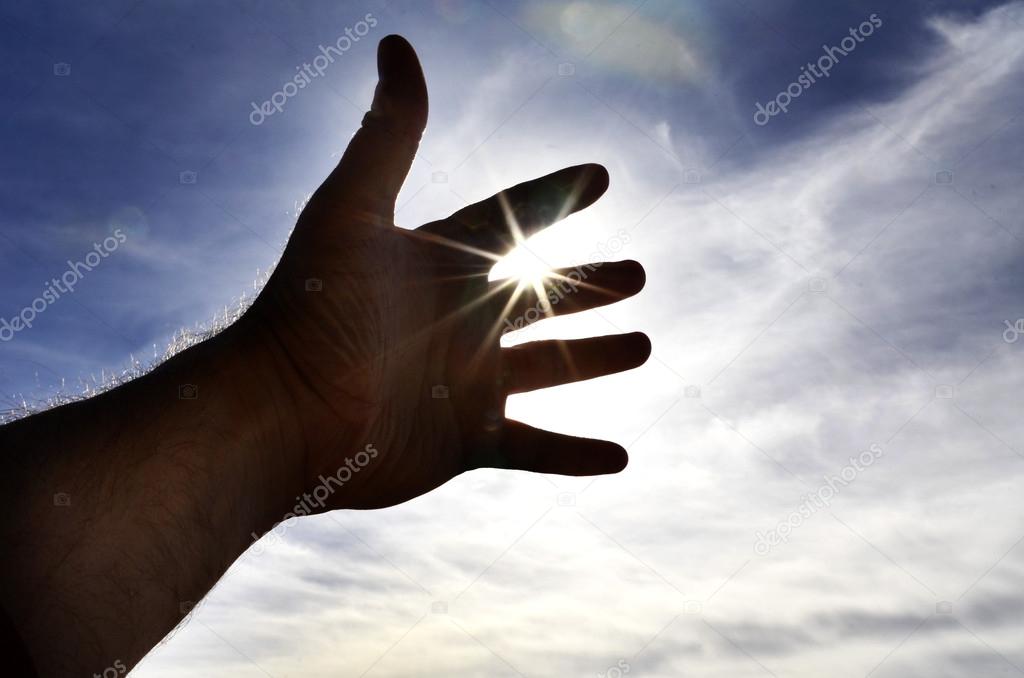 Person's Hand Reaching Towards Heaven Sunlight