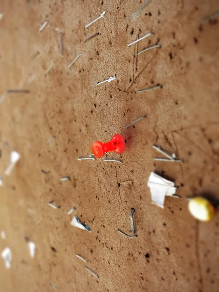 Red Tack and Staples on Bulletting Board — стоковое фото