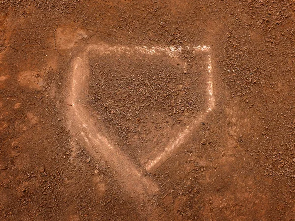 Baseball home plate in fresh dirt on a ball diamond for competition in a game scoring