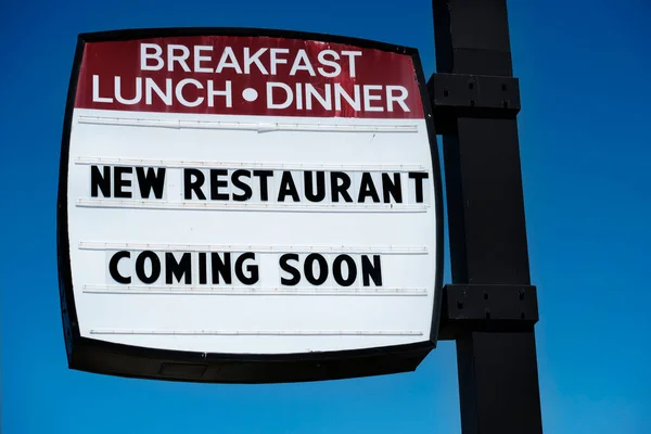 Sign for a new restaurant coming soon for breakfast lunch and dinner diner cafe