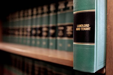 Lawbooks on shelf title for study legal knowledge landlord and tenant law clipart