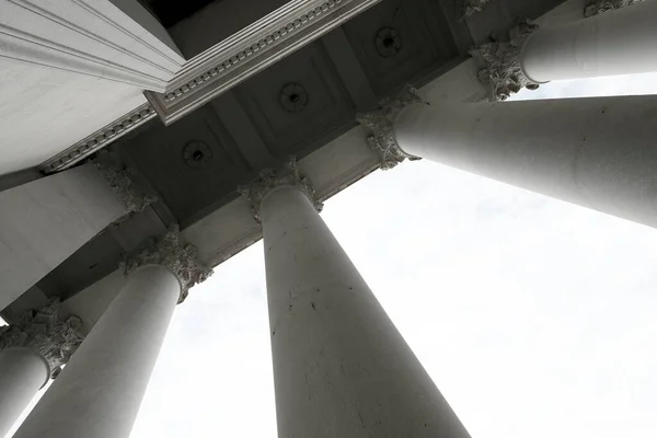 Columns of marble on a building pavilion showing architecture design and decorative structure with light and shadows